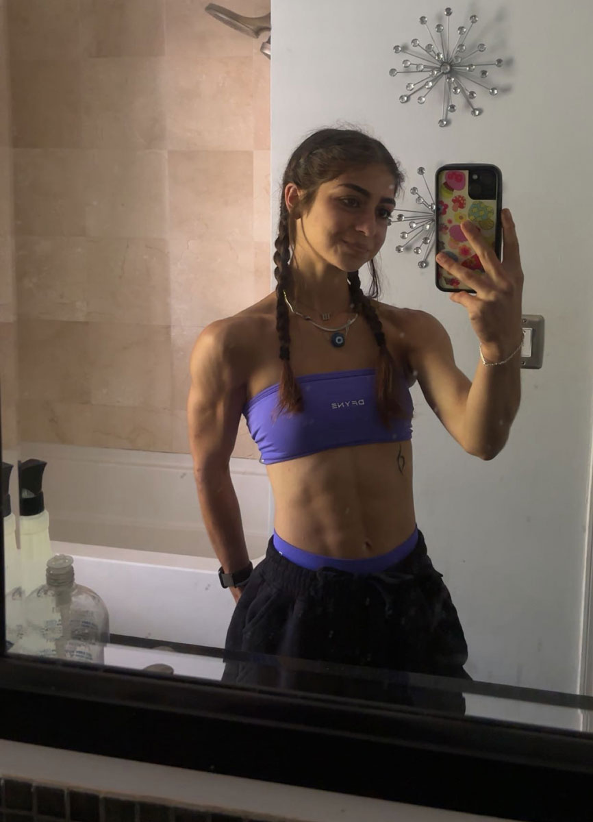 The coach is smiling while looking at the mirror.